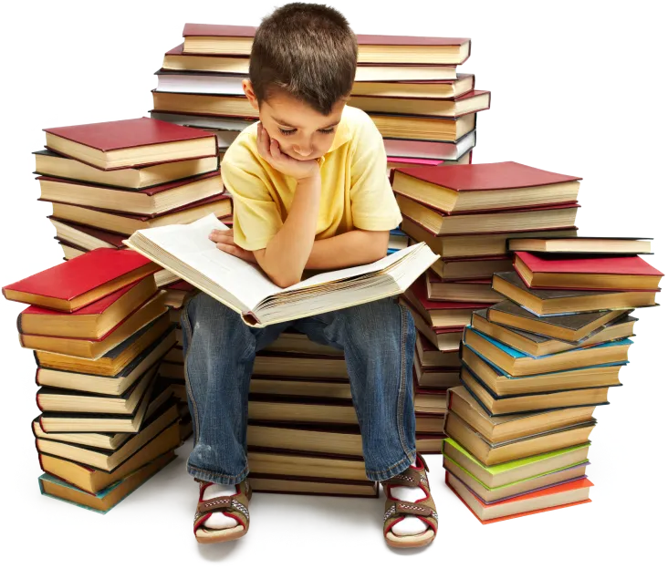 a young kid reading a self published children's book while sitting on pile of books